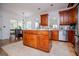 Spacious kitchen featuring stainless steel refrigerator, wood cabinets and a center island at 204 Pinehurst Way, Carrollton, GA 30116