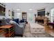 Cozy living room featuring a stone fireplace, high ceilings, and a seating arrangement at 204 Pinehurst Way, Carrollton, GA 30116