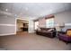 Cozy basement living room with plush carpeting, a comfortable leather sofa, and ample natural light at 204 Pinehurst Way, Carrollton, GA 30116