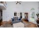 Spacious living room with soaring ceilings, large windows, and comfortable seating at 204 Pinehurst Way, Carrollton, GA 30116