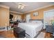 Bedroom with king bed, hardwood floors, ensuite bathroom, and natural light at 204 Pinehurst Way, Carrollton, GA 30116