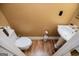 Compact powder room features a pedestal sink and toilet in a space-conscious design at 204 Pinehurst Way, Carrollton, GA 30116