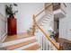 Elegant staircase with wood railings, carpeted steps, and decorative wall paneling for a stylish entrance at 204 Pinehurst Way, Carrollton, GA 30116