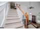 Open floor plan features a carpeted staircase leading to the upper level with views of the living area at 204 Pinehurst Way, Carrollton, GA 30116