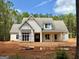 Inviting exterior view of a charming new construction home with a spacious front yard and a welcoming porch at 4 Bob Smith Rd, Sharpsburg, GA 30277