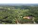 Expansive aerial view of a heavily wooded area with scattered residences, highlighting a serene and private living environment at 500 Happy Hollow Rd, Villa Rica, GA 30180