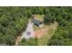 Aerial view of modern black home surrounded by lush trees and land at 500 Happy Hollow Rd, Villa Rica, GA 30180