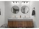 Bathroom features a double sink vanity with circular mirrors and cabinet storage below at 500 Happy Hollow Rd, Villa Rica, GA 30180