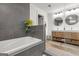 Stylish bathroom featuring a soaking tub and vanity with dual sinks and storage at 500 Happy Hollow Rd, Villa Rica, GA 30180