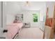Bright bedroom featuring twin beds, built in shelving, and light wood flooring at 500 Happy Hollow Rd, Villa Rica, GA 30180