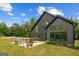 Modern home's exterior with a patio, outdoor seating, and large windows showcasing the home's architecture and design at 500 Happy Hollow Rd, Villa Rica, GA 30180