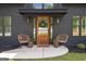 Inviting front entrance with wood door, stylish decor, and chairs at 500 Happy Hollow Rd, Villa Rica, GA 30180