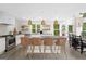Bright kitchen with a large island, modern lighting, stainless steel appliances, and a view of the greenery outside at 500 Happy Hollow Rd, Villa Rica, GA 30180
