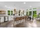 Modern kitchen with a spacious island, stylish pendant lighting, and views of the green yard through large windows at 500 Happy Hollow Rd, Villa Rica, GA 30180