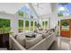 Light-filled living room featuring high ceilings, large windows offering stunning views, and comfortable seating at 500 Happy Hollow Rd, Villa Rica, GA 30180