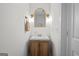 Cozy powder room featuring a wood vanity, gold fixtures, and mirror at 500 Happy Hollow Rd, Villa Rica, GA 30180