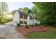 Charming two-story home with wood siding, a well-manicured lawn, and lush landscaping at 1858 Mcconnell Rd, Grayson, GA 30017
