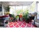 Cozy screened porch filled with plants, furniture and an interesting red and white pattern rug at 1858 Mcconnell Rd, Grayson, GA 30017