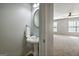 Bathroom featuring a pedestal sink, towel, and door to bedroom at 56 American Walk, Peachtree City, GA 30269