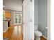 Bathroom with toilet, light-grey walls, and a partial view of the kitchen at 56 American Walk, Peachtree City, GA 30269