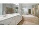 Lavish bathroom featuring double sink vanities, soaking tub and tile flooring at 56 American Walk, Peachtree City, GA 30269