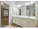 Bathroom with double sinks, large mirrors, and tile floor at 56 American Walk, Peachtree City, GA 30269