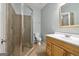 Bright bathroom featuring a tiled shower, wood vanity, and tile flooring at 56 American Walk, Peachtree City, GA 30269