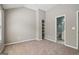 Spacious bedroom with neutral carpet and convenient built-in shelving and ensuite bathroom at 56 American Walk, Peachtree City, GA 30269
