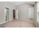 Bedroom with neutral carpeting, a window and three door openings at 56 American Walk, Peachtree City, GA 30269