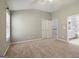 Bright, carpeted bedroom with vaulted ceilings and an attached bathroom at 56 American Walk, Peachtree City, GA 30269