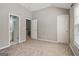 Bedroom with neutral carpeting, a window and three door openings at 56 American Walk, Peachtree City, GA 30269
