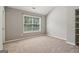 Neutral bedroom offering a large window, carpet, and built in shelving at 56 American Walk, Peachtree City, GA 30269