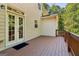 Charming covered deck with double doors and wood railings at 56 American Walk, Peachtree City, GA 30269