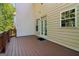 Covered deck features access to the house with wood floor at 56 American Walk, Peachtree City, GA 30269