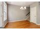 Cozy dining area boasts hardwood floors, a modern chandelier, and neutral paint at 56 American Walk, Peachtree City, GA 30269