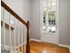 Bright entryway featuring hardwood floors, staircase, and a glass-paned door leading to the outdoors at 56 American Walk, Peachtree City, GA 30269