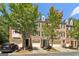 Brick townhomes featuring attached garages and well-maintained landscaping, creating a welcoming curb appeal at 56 American Walk, Peachtree City, GA 30269