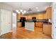 Bright, updated kitchen boasts wood cabinetry, a center island, and stainless steel appliances at 56 American Walk, Peachtree City, GA 30269