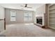 Spacious living area features a brick fireplace, custom bookshelves, and soft, neutral carpet at 56 American Walk, Peachtree City, GA 30269