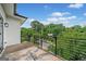 Outdoor balcony featuring modern railings and neighborhood views and easy access from the main bedroom at 32 Walthall Ne St # A, Atlanta, GA 30307
