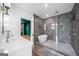 Modern bathroom featuring a soaking tub, glass-enclosed shower, dual vanity, and stylish tile work at 32 Walthall Ne St # A, Atlanta, GA 30307