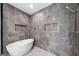 Luxurious bathroom featuring freestanding tub, tiled walls, open shower, and inset shelving at 32 Walthall Ne St # A, Atlanta, GA 30307