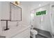 Bathroom featuring single sink vanity, glass shower and patterned tile at 32 Walthall Ne St # A, Atlanta, GA 30307