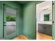 Bathroom with vanity and sink, modern mirror, and doorway to outdoor deck at 32 Walthall Ne St # A, Atlanta, GA 30307