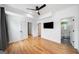 Bedroom featuring hardwood floors, ceiling fan, and doors leading to ensuite bath and closet at 32 Walthall Ne St # A, Atlanta, GA 30307