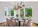 Bright dining room featuring large windows, modern lighting fixture, and an elegant dining set at 32 Walthall Ne St # A, Atlanta, GA 30307