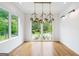 Bright dining room featuring hardwood floors, modern lighting fixture, and large windows at 32 Walthall Ne St # A, Atlanta, GA 30307