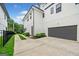 Side view of a modern two-story home featuring a driveway and an attached garage at 32 Walthall Ne St # A, Atlanta, GA 30307