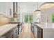 Modern kitchen featuring an island, gas range, stainless steel hood, and plenty of cabinet space at 32 Walthall Ne St # A, Atlanta, GA 30307
