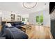 Open concept living area with hardwood floors, modern lighting, and view into kitchen with eat-in island at 32 Walthall Ne St # A, Atlanta, GA 30307